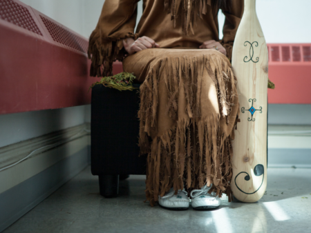 A close shot of a student displaying traditional Wabanaki Regalia for Indigenous people.