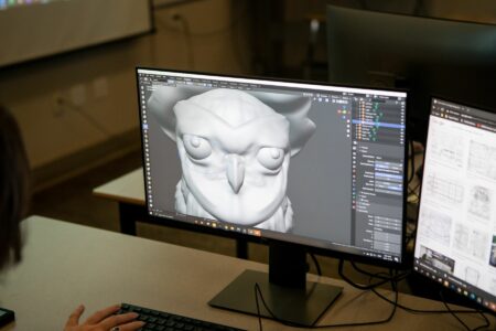 A goblin-type creature's fan is seen on the screen. It is 3d-modelled and an NBCCD 3D Digital Design student made it.