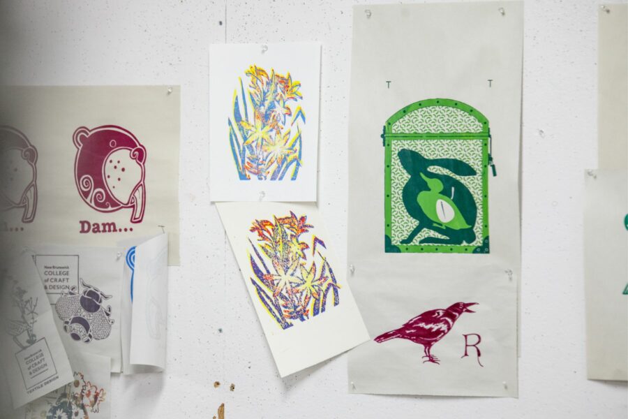 Examples of different screen printed work on paper. Hung on the walls of the New Brunswick College of Craft and Design Textile Design Studio.