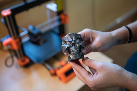 An image of a 3D printed skull. It looks like it's a cyberpunk robot skull. It's been printed by an NBCCD student.