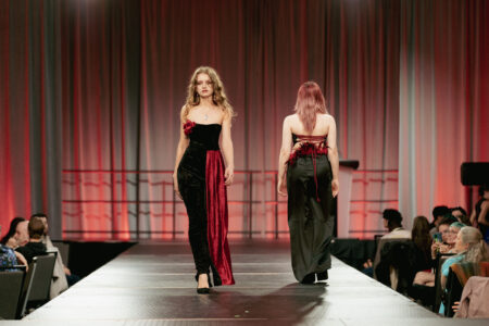 Model walking the runway in a design by Favour Abereko at the NBCCD Fashion Show 2025.