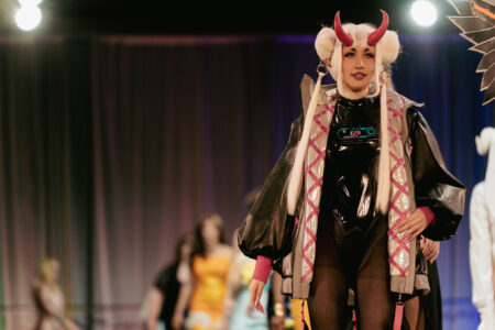 Model walking the runway in a design by Jessica Calhoun at the NBCCD Fashion Show 2025.