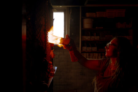 NBCCD Ceramics student, Dimitra Bountalas, loading a gas kiln.