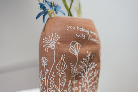 A ceramic artwork by a student, Kim Benoit, displayed on a gallery exhibition.